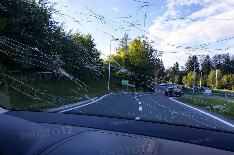 Shattered windscreen due to hailstones on a car