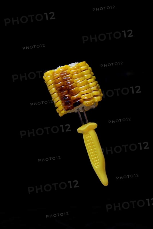 Grilled corn on the corn cob on a corn on the cob holder