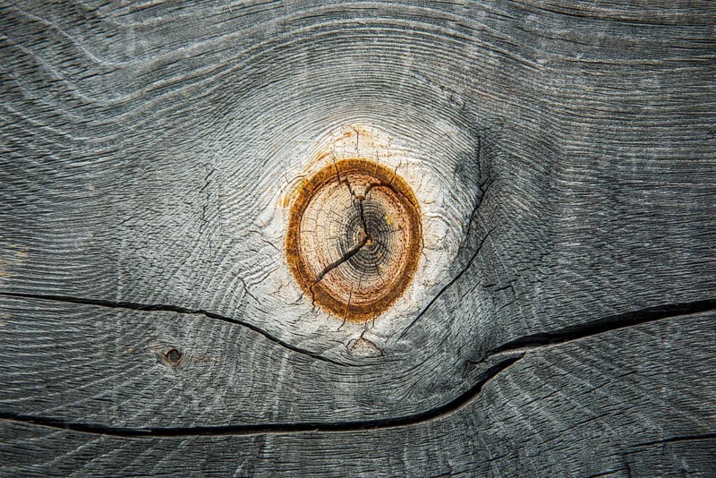 Weathered wood with knothole at an alpine hut