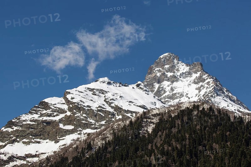 Snowcapped mountains against blue sky