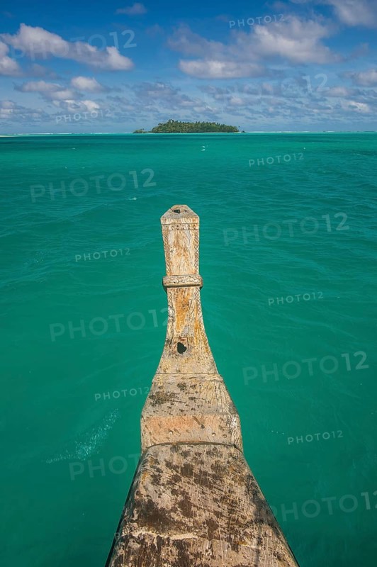 Traditional wood carved boat in the Aitutaki lagoon