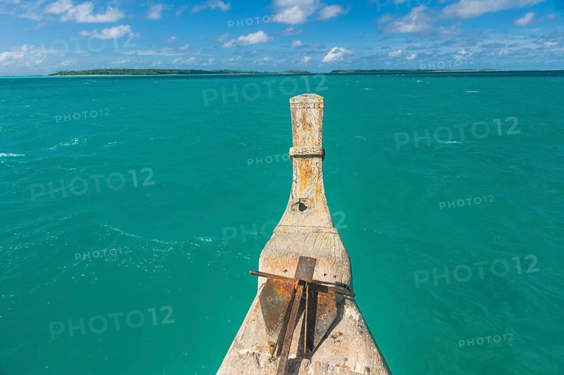 Traditional wood carved boat in the Aitutaki lagoon