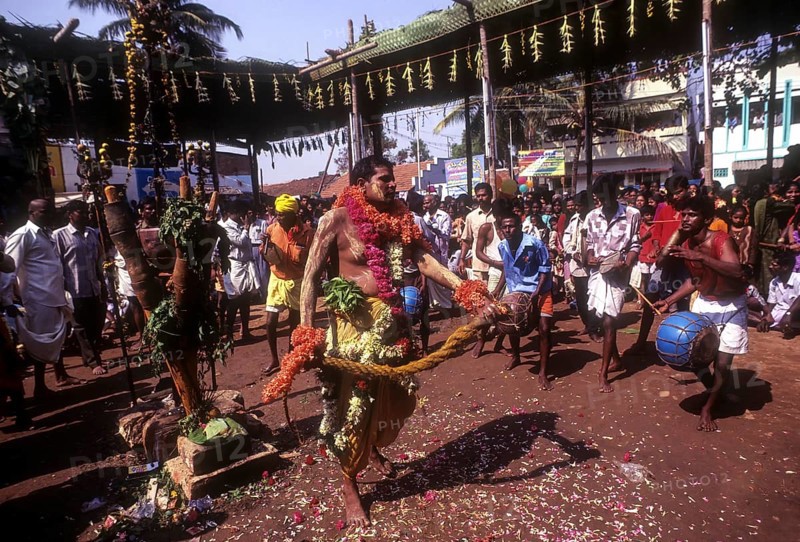 A god possessed man beating himself with whip. Mariamman festival at Coimbatore