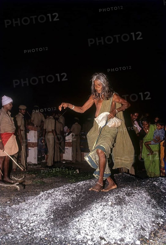 An old woman walking on burning coal
