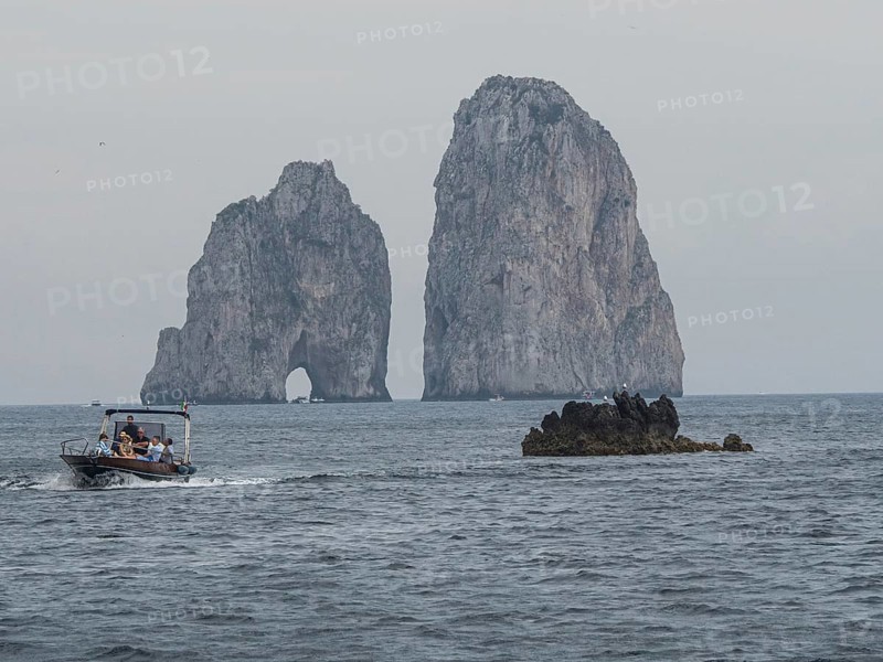 Boats in front of Faraglioni rock group