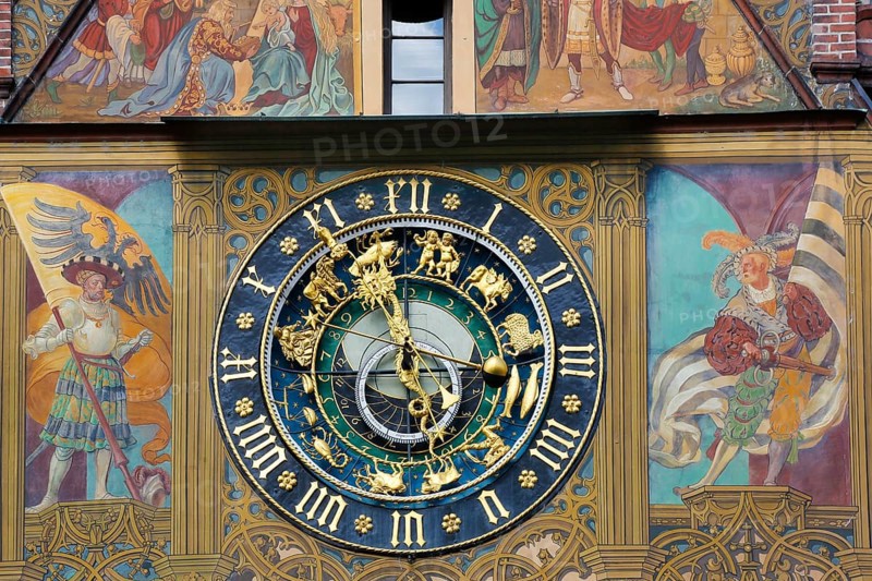 Richly decorated astronomical clock with signs of the zodiac on the town hall