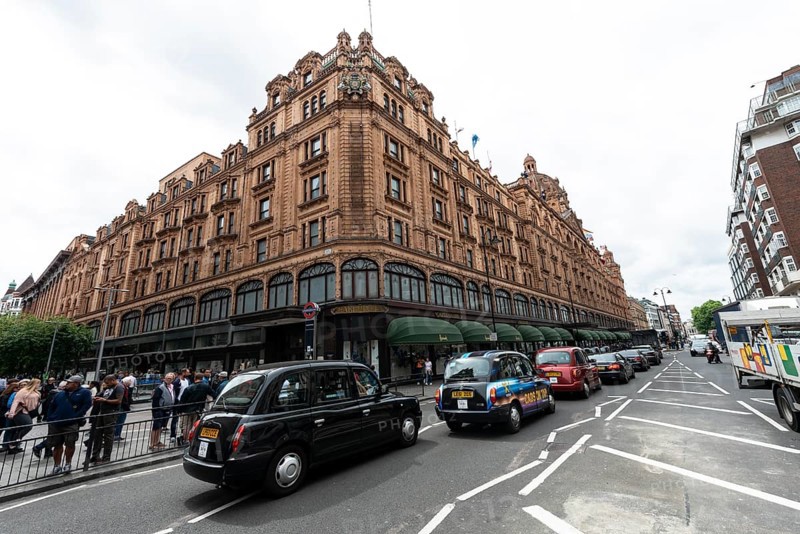 Taxis lined up on the street outside the luxury department stores