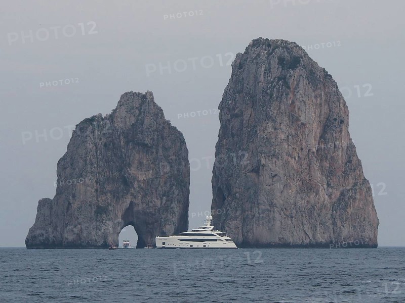 Yacht in front of Faraglioni rock group