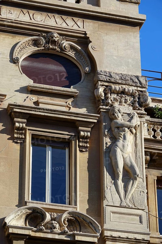 Reliefs of naked woman on the Palazzi degli Ambasciatori Embassy palaces with archway to the Quartiere Coppede