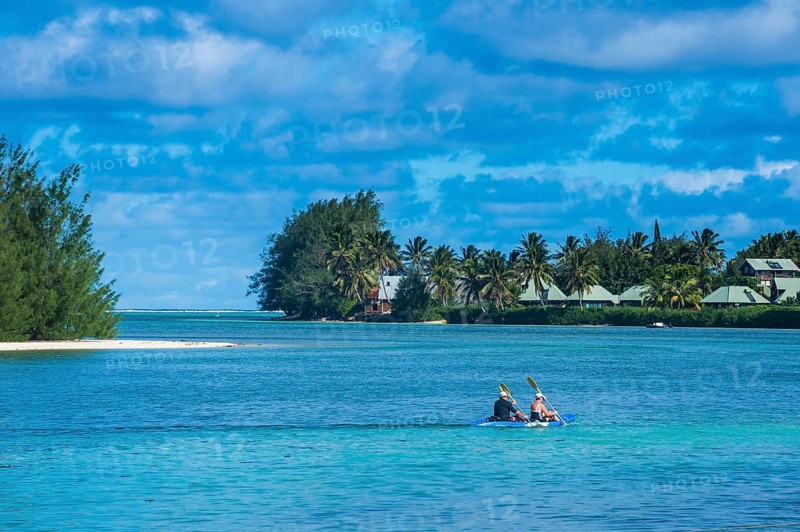 Couple kayaking in the waters of Muri beach