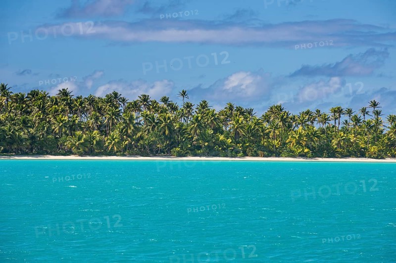 White sand beach and palm fringed beach in Aitutaki lagoon