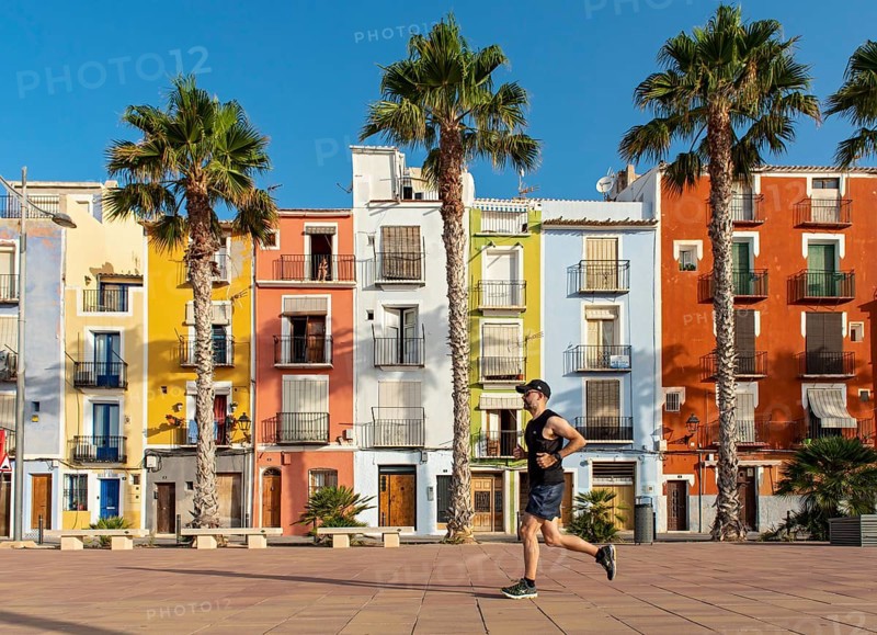 Runner in front of Colorful beachfront houses