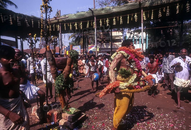 A god possessed man beating himself with whip. Mariamman festival at Coimbatore