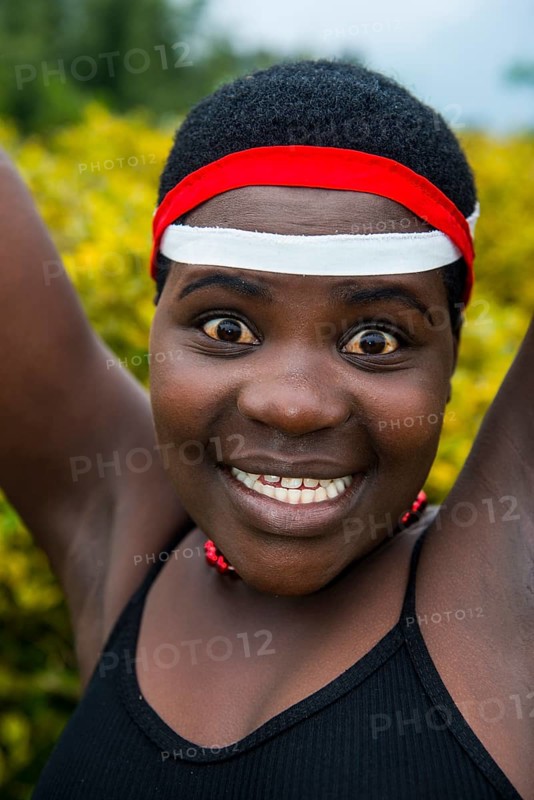 Woman starring at the camera at a ceremony of former poachers