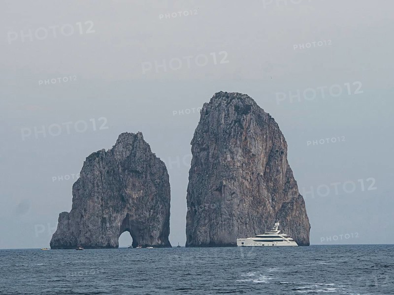 Yacht in front of Faraglioni rock group
