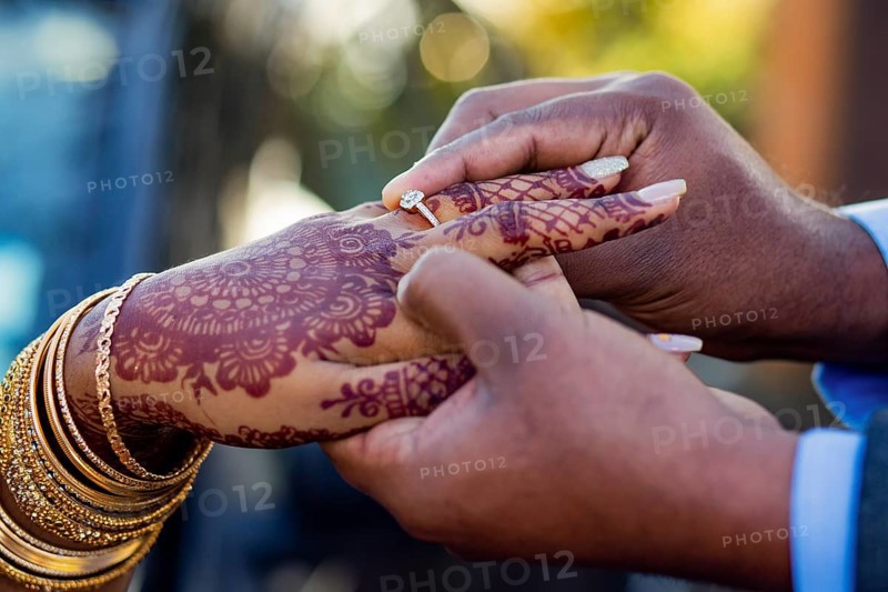 Engagement ring ceremony of a Mauritian Hindu couple. Groom passing ring in his bride`s finger