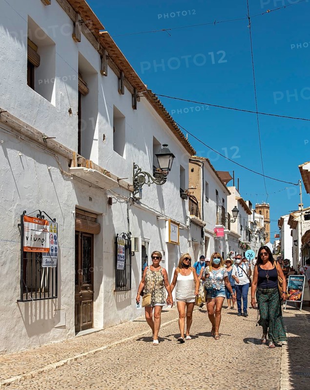Group of tourists in narrow streets of Altea Old Town