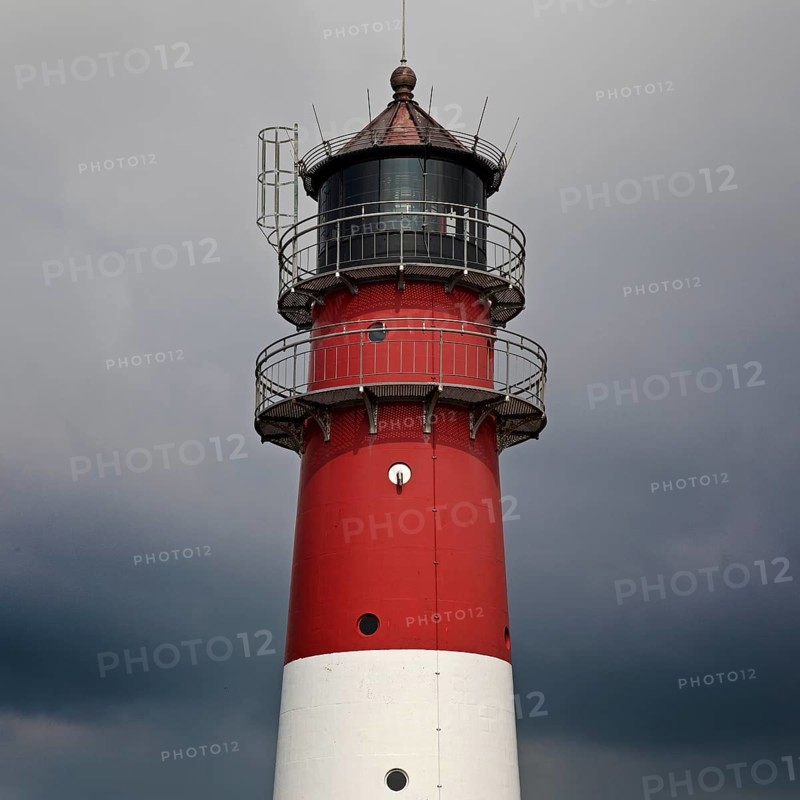 Lighthouse in front of dark clouds