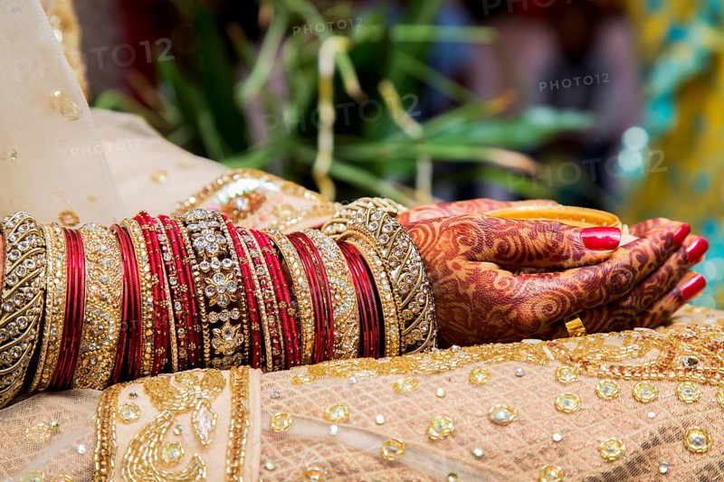 Traditional bridal jewelry and henna decoration on the hands of a bride during a religious ceremony at a Hindu wedding