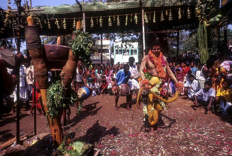 A god possessed man beating himself with whip. Mariamman festival at Coimbatore