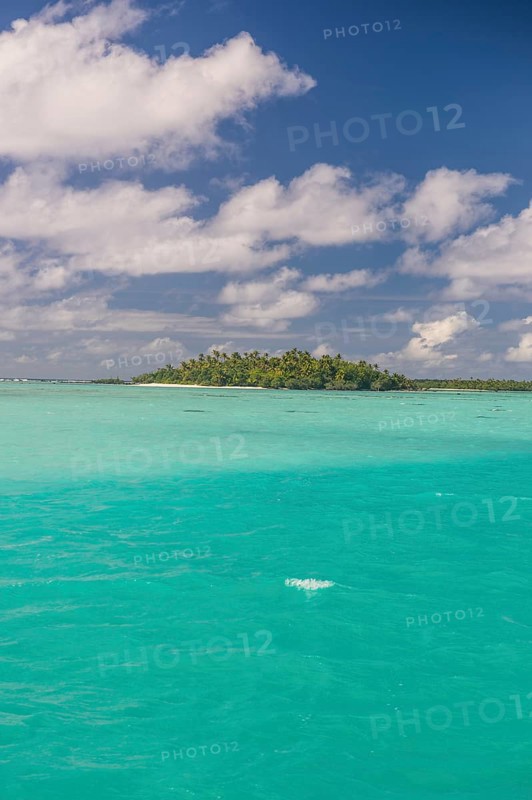 White sand beach and palm fringed beach in Aitutaki lagoon
