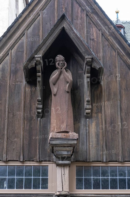 Wooden figure of John the Baptist above the portal of the Protestant St. John's Church in Wernigerode