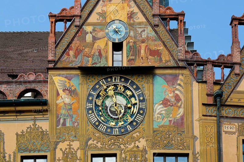 Richly decorated astronomical clock with signs of the zodiac on the town hall