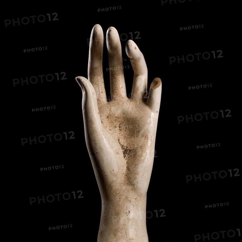 A shop window dummy hand on a black background