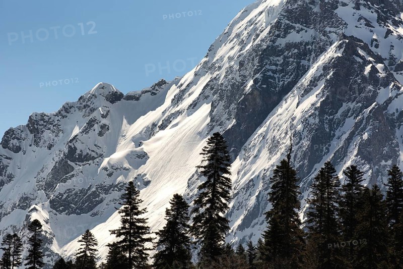 Snowcapped mountains against clear blue sky