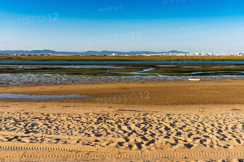 City of Faro seen from Faro Beach Peninsula with wetlands of Ria Formosa in between