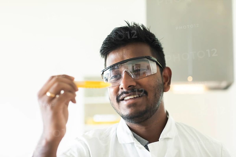Student in an internship at the university with sample and lab coat