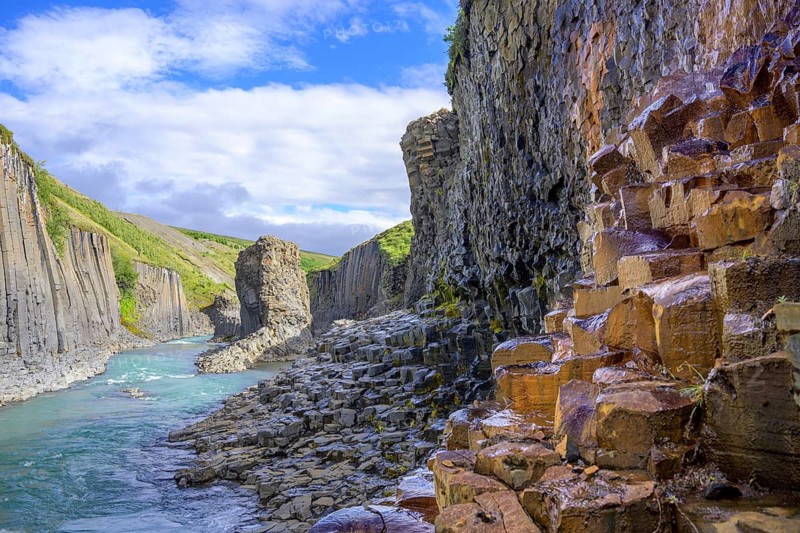 Basalt columns coloured orange by iron oxide