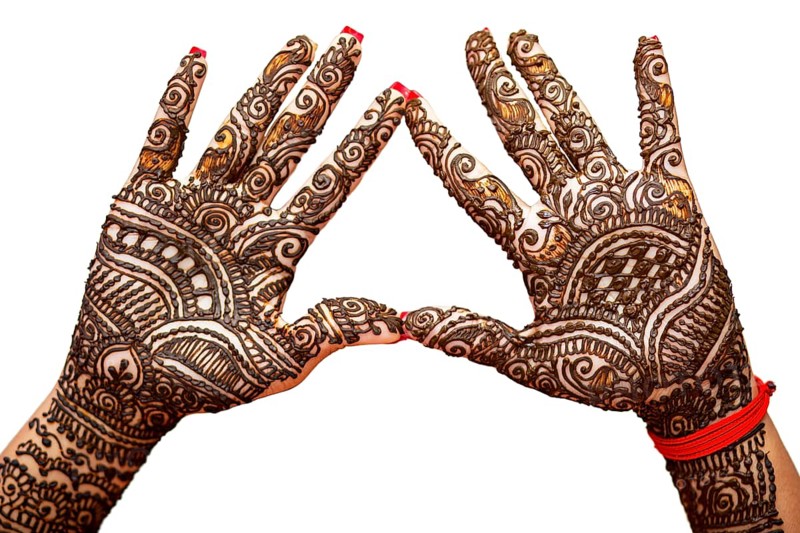 Indian Bride's hand painted with mehndi isolated on white background. Mauritius