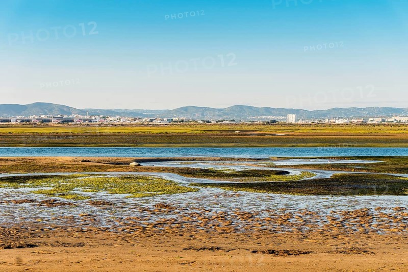 City of Faro seen from Faro Beach Peninsula with wetlands of Ria Formosa in between