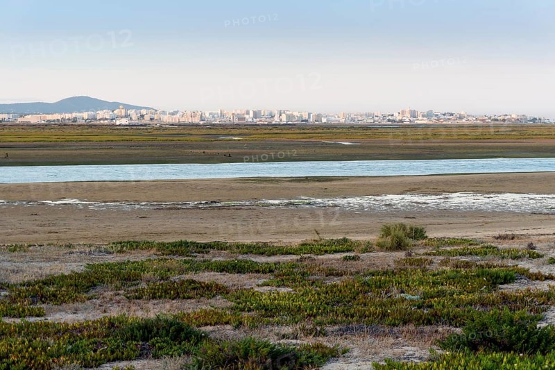 City of Faro seen from Faro Beach Peninsula with wetlands of Ria Formosa in between