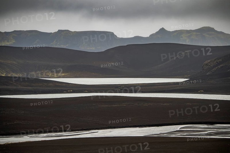 River and lakes in black lava desert