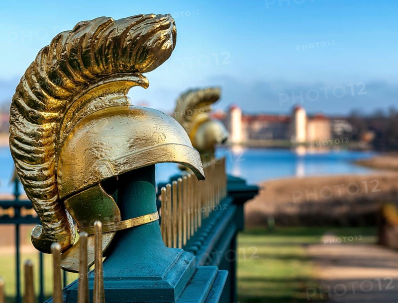 Restored fence with gold helmets at the Lake Grienerick obelisk in Rheinsberg