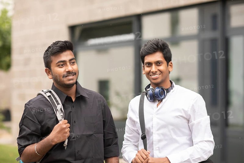 Students outside with bag in front of the university