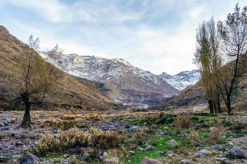 Beautiful valley with stream in Atlas mountain by sunset