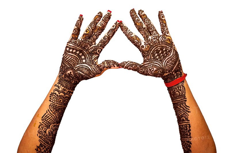 Indian Bride's hand painted with mehndi isolated on white background. Mauritius