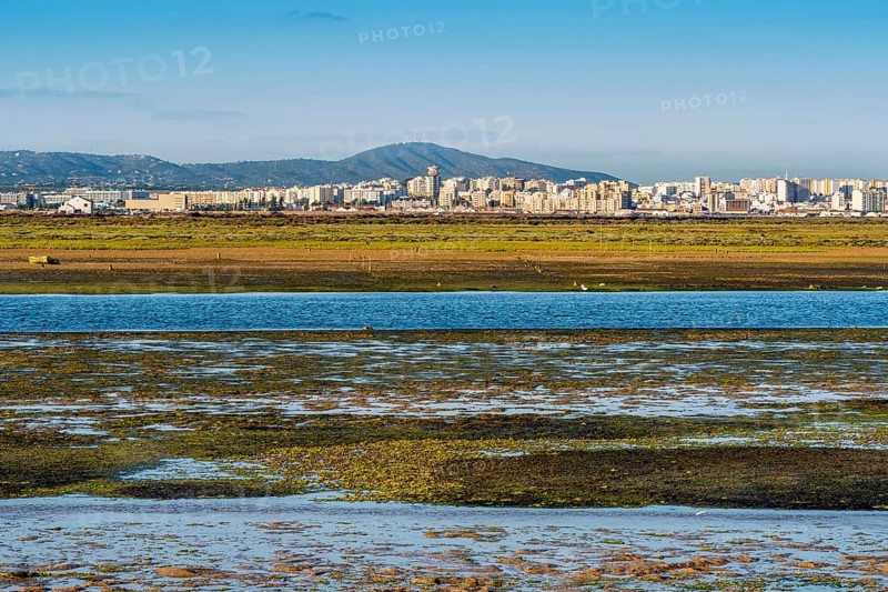 City of Faro seen from Faro Beach Peninsula with wetlands of Ria Formosa in between