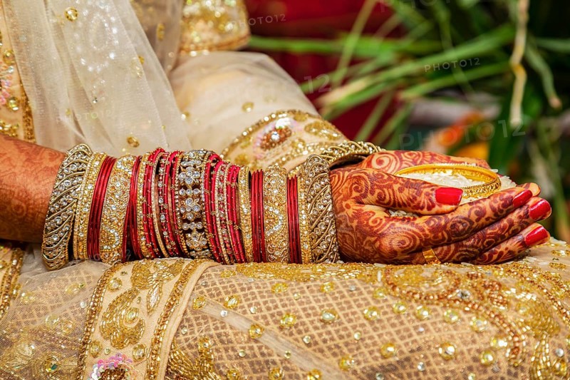 Traditional bridal jewelry and henna decoration on the hands of the bride during a religious ceremony at a Hindu wedding