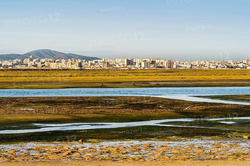 City of Faro seen from Faro Beach Peninsula with wetlands of Ria Formosa in between