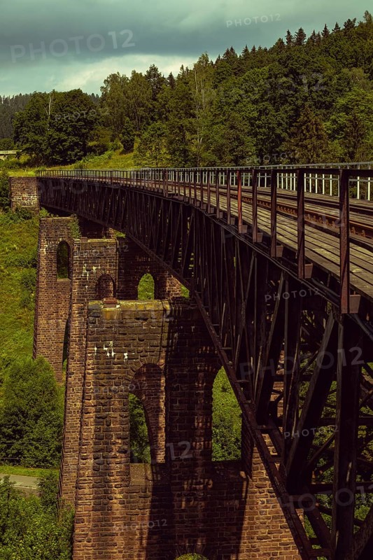 Old stone railway viaduct in the mountains