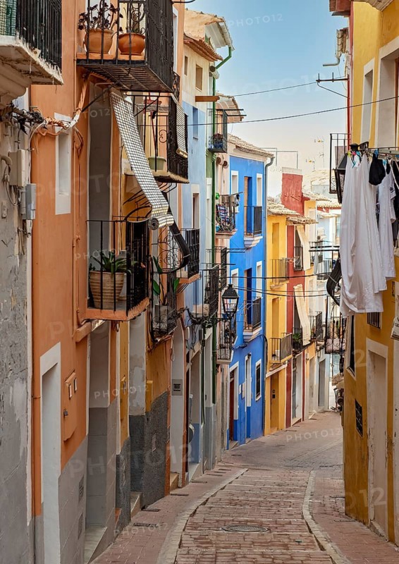 Narrow street with colorful houses in seaside town of Villajoyosa
