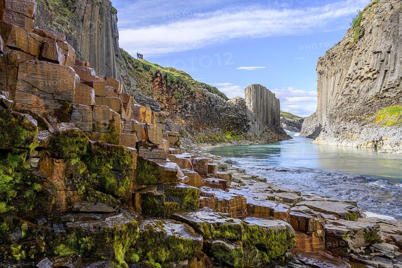 Basalt columns coloured orange by iron oxide