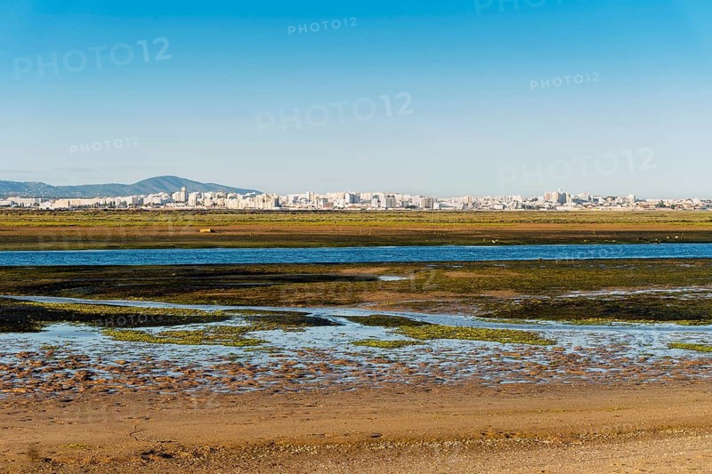 City of Faro seen from Faro Beach Peninsula with wetlands of Ria Formosa in between