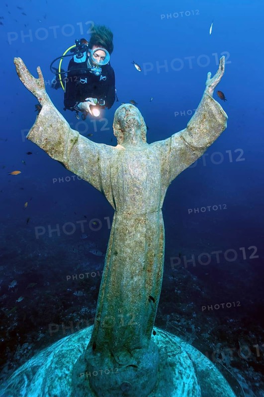 Diver looking at statue of Christ