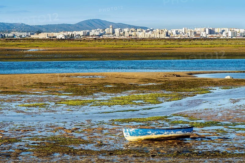 Boat by Ria Formosa wetlands during low tide