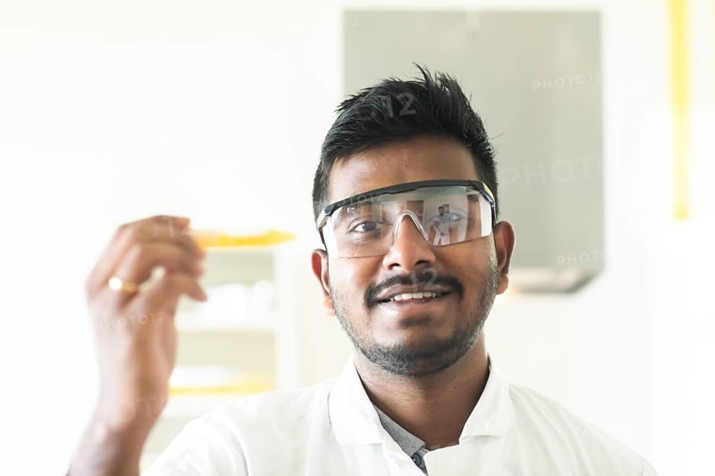 Student in an internship at the university with sample and lab coat